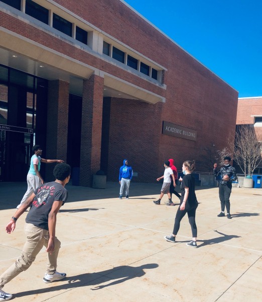 Students toss the football in the courtyard by the Academic Building.